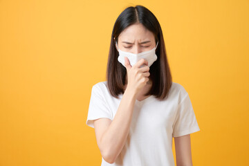 Asian women wear masks to protect disease on orange background.