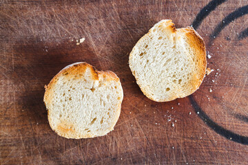 simple food ingredients, close-up of fresh bread slices on wooden cutting board