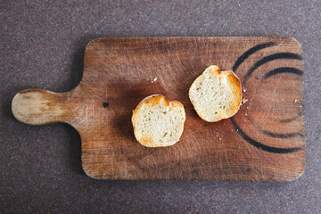 simple food ingredients, close-up of fresh bread slices on wooden cutting board