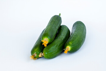 Fresh cucumbers heap on white surface with copy space