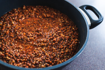 plant-based food, vegan lentil and textured vegetable protein ragu with quinoa in pot