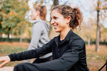 Fototapeta premium Women training with trx outside in the park.
