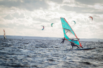 Jastarnia, Poland, July, 8, 2020. Racing windsurfers seen from the side.