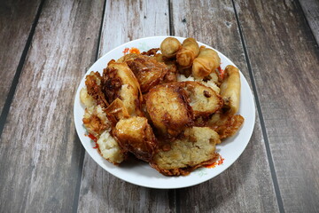Traditional deep fried cutting Chinese radish wrapped with tofu sheet and spring roll on the plate....