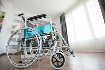 Wheelchair in recovery room of nursing facility for handicapped people. No patient in the room in...