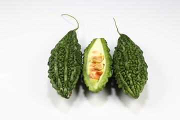 Fresh bitter gourd isolated on the white background. Famous traditional tropical vegetable product...