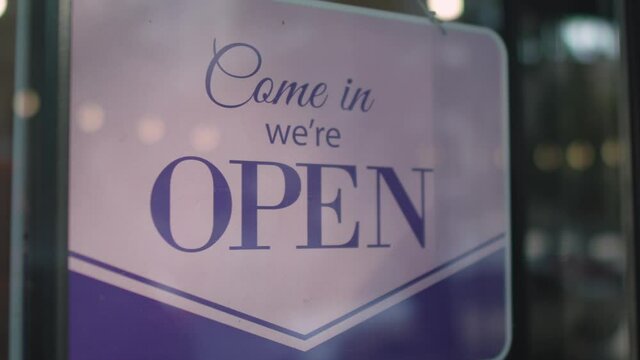 Sign sorry we are closed on a door of a bar, restaurant. Came in we are open on the window of the coffee shop, vintage black retro sign