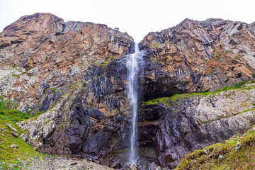 Mountain landscape with a river and a waterfall. Summer background. Belogorka gorge, Kyrgyzstan