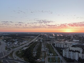 Aerial view panoramic landscape of Moscow city at sunrise. Multi-level intersection on an expressway in the city in the rays of the golden sun. Drone shot