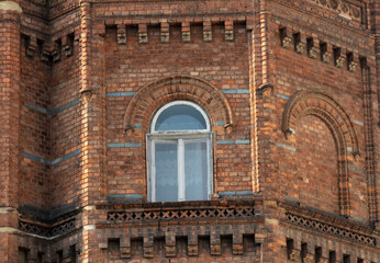 Obraz premium Corner of the facade of an old brick house in Europe