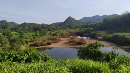 Fototapeta premium Bangkok to Chiang Mai Class 3 Train view lake in the mountains