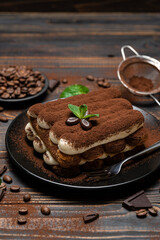 Fototapeta na wymiar Classic tiramisu dessert on ceramic plate on wooden background