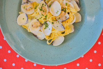 Linguine with clams. Traditional Italian pasta with clams and other sea food. Healthy meal. Eating out in restaurant.