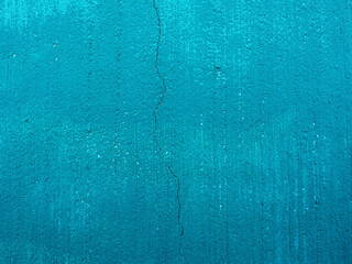 concrete wall painted with blue paint with crack