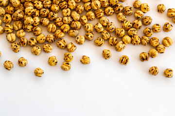 Roasted yellow chickpeas background on white with copy space.Top view