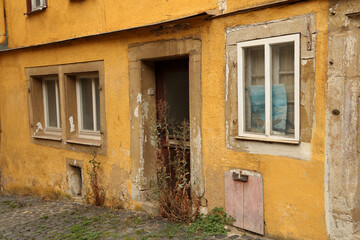 Fototapeta na wymiar The entrance to an old abandoned house