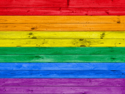 colorful rainbow lgbt flag on wood panel wall background.
