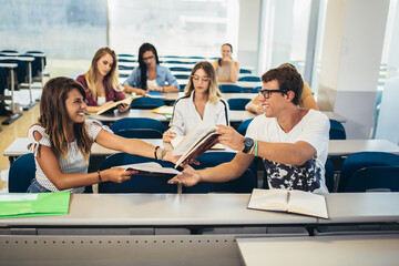 Fototapeta premium Concentrating students sitting at the college lecture hall