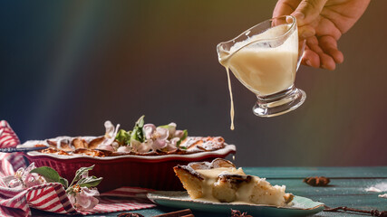 vanilla cream pouring on cheesekace piece. Cheesecake with creamy sweet topping. Long banner format. space for text