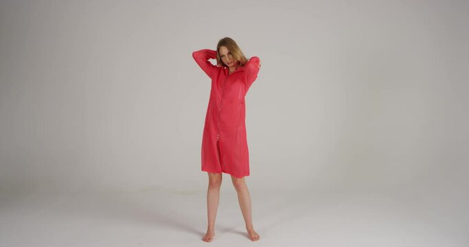 4K Slow Motion Of Model In Neon Dress Putting A Hood On