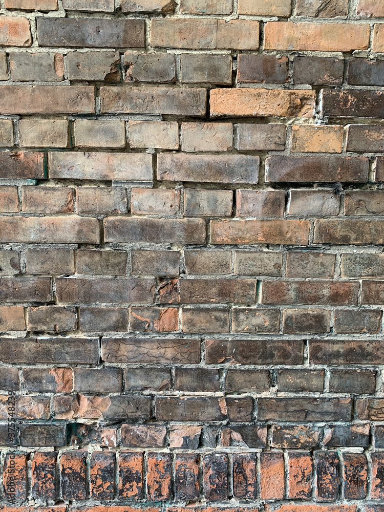 Sticker Vertical closeup shot of an old brick wall