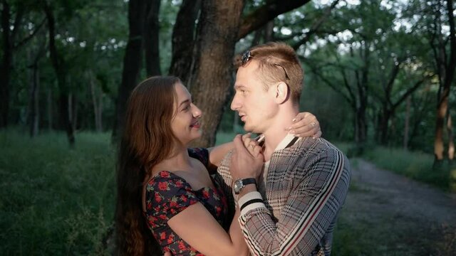 Portrait cute young smile couple. Happy people, relationship concept. girl does not let man say holding finger to mouth