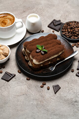 Classic tiramisu dessert, cup of coffee, sugar and milk on concrete background