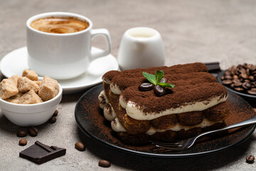 Fototapeta na wymiar Classic tiramisu dessert, cup of coffee, sugar and milk on concrete background
