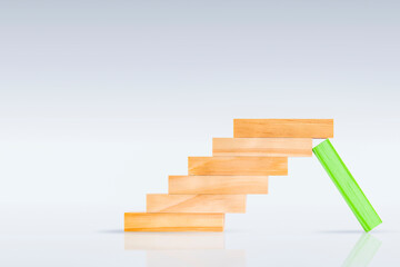 one green block holds the ladder from the block. business concept