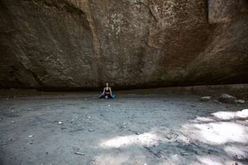 Woman sitting on ground in mountains. Deep meditative state inside Meditation. Contemplation or Yoga concept