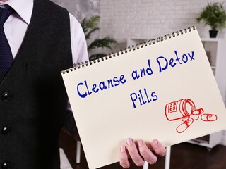 Healthy concept about Cleanse And Detox Pills with phrase on the piece of paper.