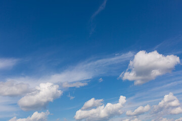 White clouds on blue sky background.
