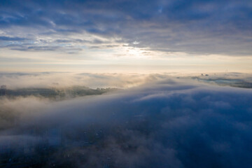 The sun breaks through the fog in the city! Above the clouds and below the fog! Somewhere a river!