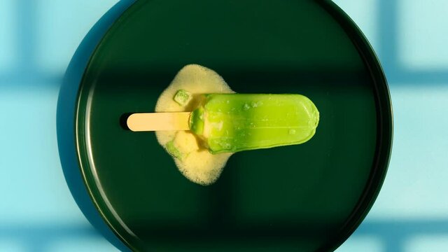 fresh chocolate outer with durian filling popsicle melting in the shadow of a window timelapse 