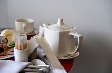 Fototapeta na wymiar still life with coffee service breakfast on a red tablecloth