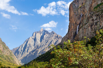 Mountain landscape with a river and a waterfall. Summer background. Belogorka gorge, Kyrgyzstan