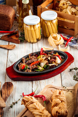 Roasted meat with vegetables in cast iron pan