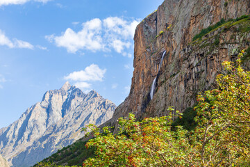 Mountain landscape with a river and a waterfall. Summer background. Belogorka gorge, Kyrgyzstan