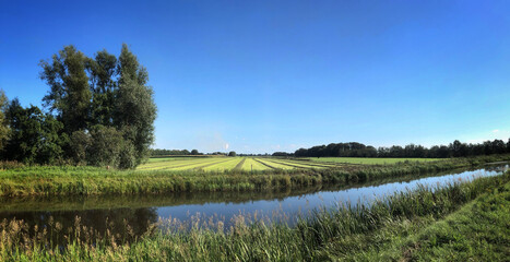 Landscape. meadows with canal. Havelte. Meenthe. Drenthe Netherlands. Panorama. Grasdrogerij Ruinerwold.