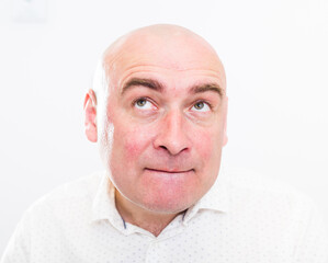portrait of bald adult mature man with emotions on white background