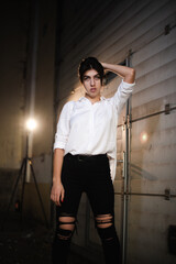 Girl in a leather jacket on an old abandoned construction site