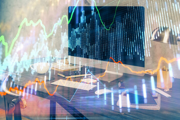 Financial graph colorful drawing and table with computer on background. Double exposure. Concept of international markets.