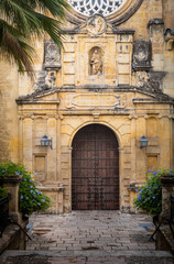 Famous landmark in Spain. Brown door in old arabic style in Cordoba