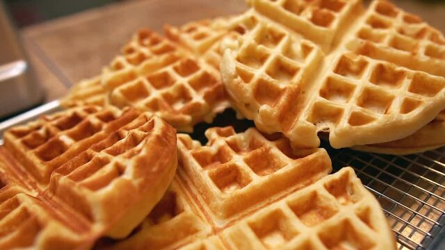 Freshly made waffles cooling and ready for a big family breakfast feast - push forward close up