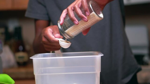 Adding sugar to the flour for a homemade batter or dough recipe - slow motion