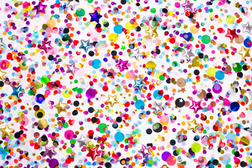 Colorful paper and foil round and star confetti wallpaper. Party pattern on white background....