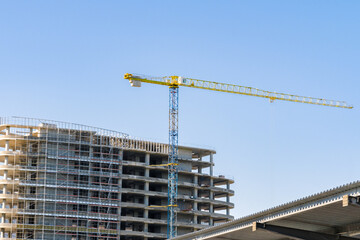 Fototapeta premium construction crane at the construction site of a high-rise building