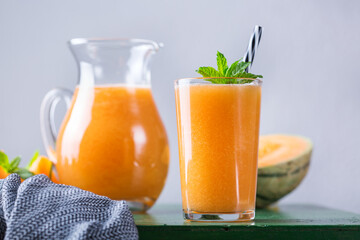 Fresh organic melon cantaloupe smoothie on a kitchen table