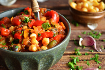 Vegetable goulash without meat in a green rustic bowl