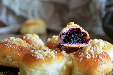 Sweet crumble buns filled with blueberries on a rustic tray